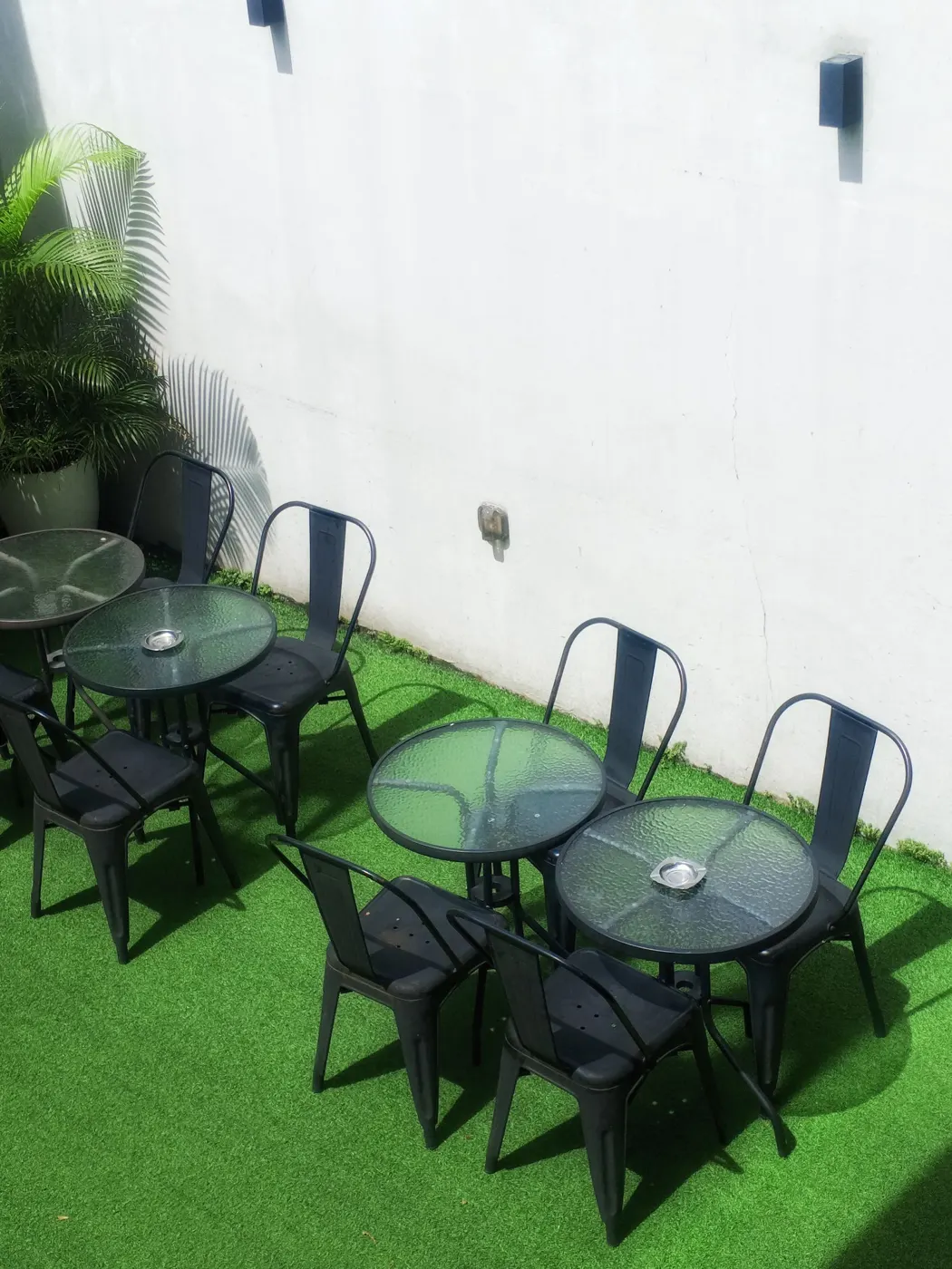 Aerial view of outdoor seating with tables and chairs on artificial grass